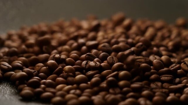 Closeup of roasted coffee beans: dynamic view of fresh aromatic beans in motion