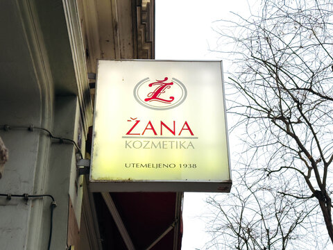 Zana Kozmetika sign illuminated in soft light, showcasing elegant branding and vintage charm, representing a long-standing beauty establishment with a rich history since 1938