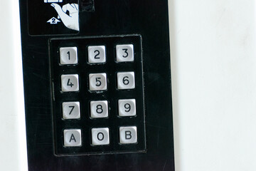 Number pad 1 to 9 with letters A and B numbers for dialing calls in a telephone booth