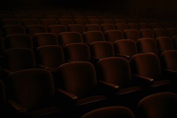 Fototapeta premium Rows of dark, unoccupied seats filling an auditorium, creating a tranquil atmosphere before an event or show begins