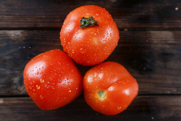 Top view fresh tomatoes on wooden board background