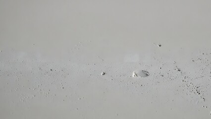 Close-up of sandy surface with small rocks and pebbles