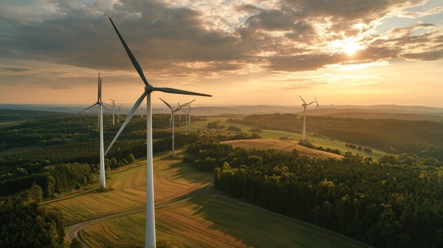 Wind turbine blades spinning gracefully against a golden sunset in a rural landscape, symbolizing renewable energy generation. - Powered by Adobe