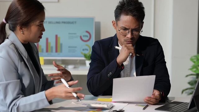Stressed business people arguing over financial report in office meeting