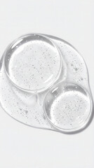 Clear liquid with tiny silver glitter particles suspended within its texture