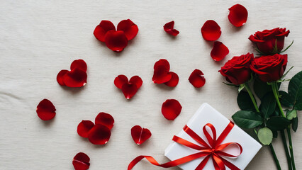 Romantic Overhead View Of Red Roses, Scattered Petals, And A White Gift Box With A Red Ribbon, Perfect For Valentine's Day