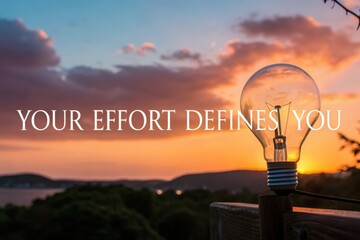Light Bulb Illuminates Sunrise Scene with Inspirational Quote About Effort