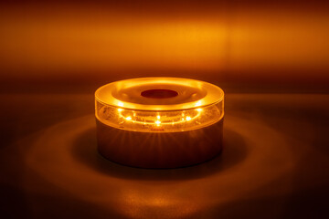 Yellow V16 emergency beacon light activated at night. Modern roadside assistance device for car breakdown safety and hazard signaling in low light.