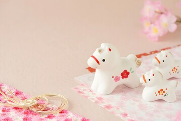 Delicate ceramic horse figurines on lace isolated on white background