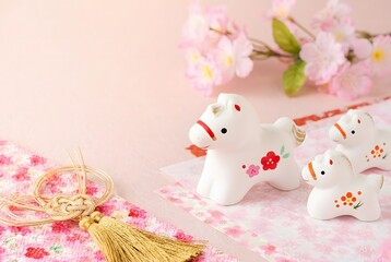 Delicate ceramic horse figurines with blossoms isolated on white background