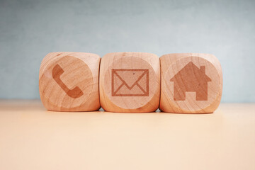 Wooden cubes with house, envelope, and phone symbols, concept of communication, home, mail, and contact, business icons, modern minimal design, office and digital connections