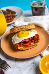 Breakfast sandwich with bacon egg and cheese on whole grain bread
