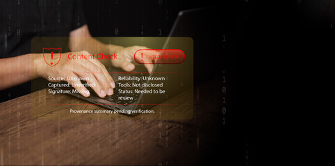 A man hands typing on laptop with red digital content warning. Cyber risk, unverified sources, misinformation, fake news, data authenticity, online verification systems, provenance, authentication.