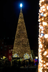 Beautiful shiny Christmas tree at night