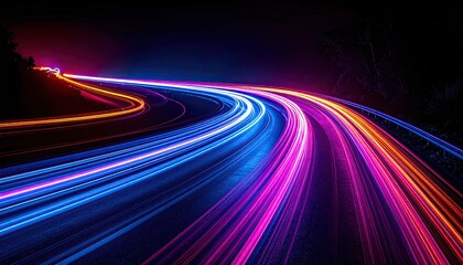 Long exposure captures vibrant streaks of light from vehicle trails curving through a dark night
