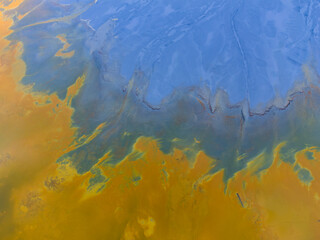 Beautiful aerial pattern of colorful water and mud, shot with a drone located at Geamana, Romania, a formerly village that was covered with toxic waste from a mining operation nearby