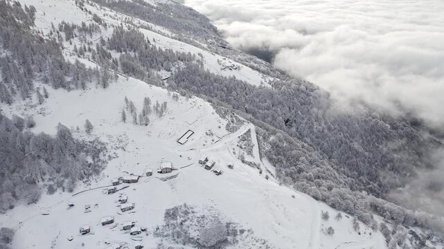 Drone point of view of the Alpe Ortighera after snowstorm, Valsassina, Lombardy, Italy landscape