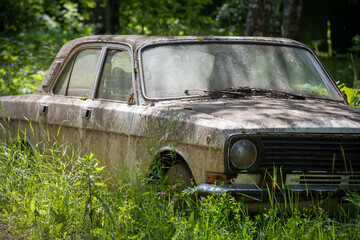 GAZ-24-10 Volga in the thick grass.  An abandoned Soviet car of the middle class produced by the Gorky Automobile Plant