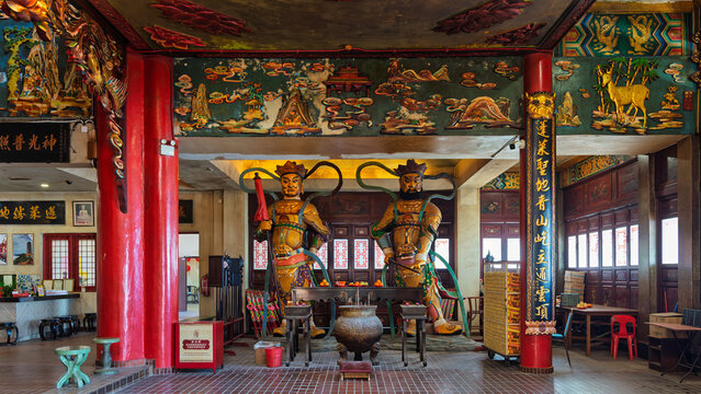 Pahang, Malaysia - Feb. 22, 2025: Interior of the Hall of Deities at Chin Swee Temple, Genting Highlands. Features vibrant guardian statues, red pillars, and detailed traditional carvings