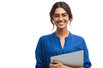 Woman smiling while holding a laptop and wearing glasses in a bright setting