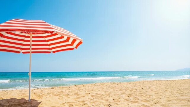 Vibrant Red And White Striped Beach Umbrella Stands Tall On A Sandy Shore Under A Clear Blue Sky With Gentle Waves In The Distance On A
