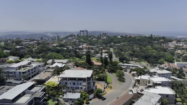 Drone flies north over neighborhood toward Jameson Park on sunny day in Windermere neighborhood in Durban, South Africa