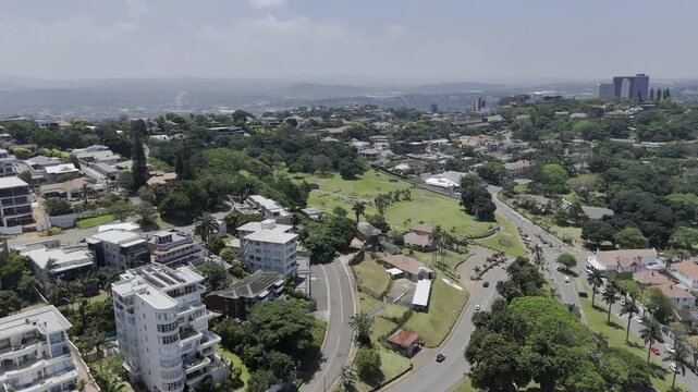 Drone flies to the left of Jameson Park on sunny day in Windermere neighborhood in Durban, South Africa