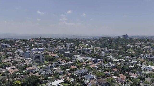 Drone flies north toward Jameson Park on sunny day in Windermere neighborhood in Durban, South Africa
