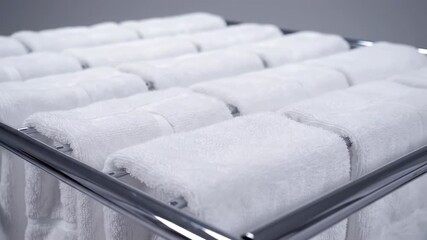 Pristine Hospitality: Close-up of neatly stacked, crisp white towels, evoking a sense of cleanliness and relaxation, perfect for spas or hotels. 