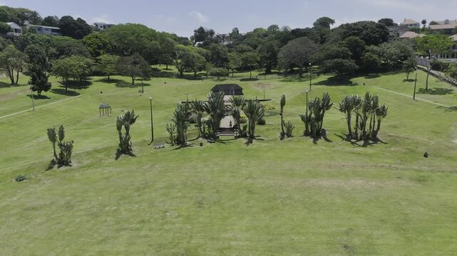 Drone flies up and away from Jameson Park on sunny day in Windermere neighborhood in Durban, South Africa