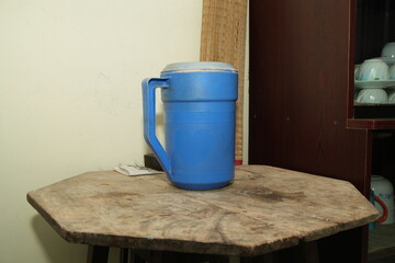 Blue Plastic Thermos on a Rustic Wooden Table