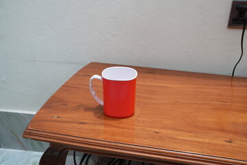 Red and White Plastic Mug on a Wooden Table