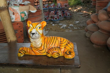 Vibrant Handcrafted Tiger Figurine Displayed in Pottery Workshop