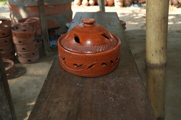 Handcrafted Terracotta Pot with Decorative Cut-outs and Lid