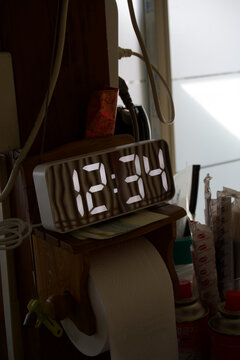 Digital clock displaying time on a kitchen counter