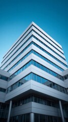 Obraz premium Building with glass windows under clear blue sky
