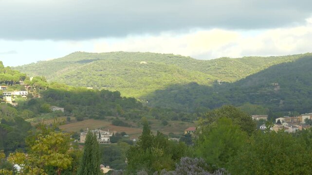 Cloud Shadows Falling Over Green Hills in Catalonia Creating Peaceful Countryside Mood