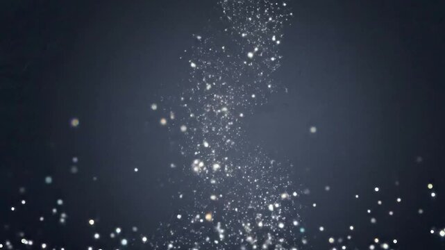 Sparkling water droplets falling against dark background