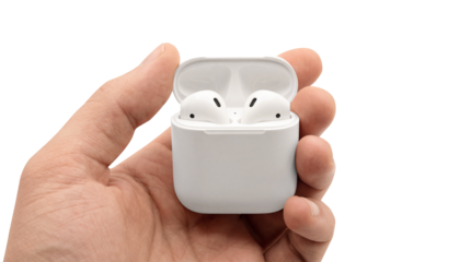 Male hand holding open white wireless earbud charging case isolated on transparent background
