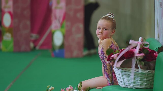 Expect judges' grades for rhythmic gymnastics, rhythmic gymnastics competitions, a little girl expects grades for rhythmic gymnastics
