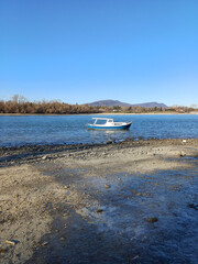 Low Water Riverbank With Boats