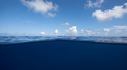 Fototapeta premium View of the open ocean shows the horizon line and white clouds
