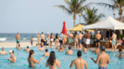 Blurred view of people relaxing at a tropical resort swimming pool with ocean view