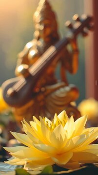 Beautiful yellow lotus flower with blurred Goddess Saraswati statue in background. Vasant Panchami festival concept video.