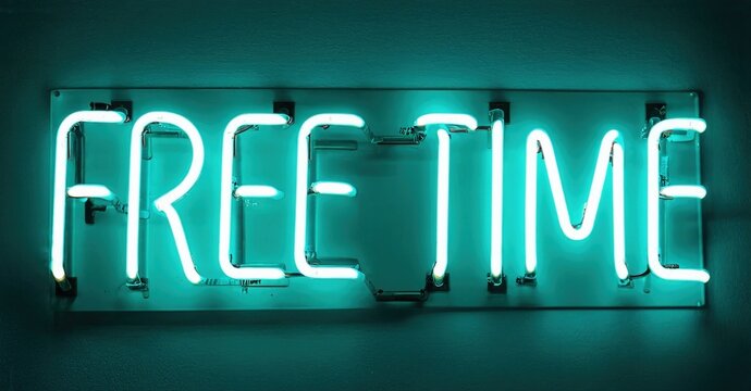 Bright neon sign displays words free time. Turquoise glow contrasts dark wall. Simple, modern aesthetic. Relaxing concept presented visually.