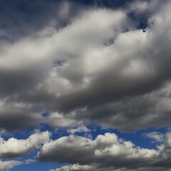 Dramatic White and Grey Cumulus Clouds Against a Deep Blue Sky