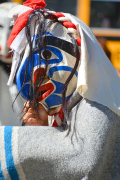VICTORIA BC CANADA 04 24 2015: Native Indian man in traditional costume and wooden mask. First Nations in BC constitute a large number of First Nations governments and peoples in the province