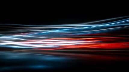 Long exposure abstract of white, red and blue light trails against a black background