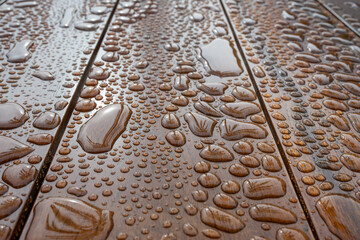 Water droplets on wooden surface with perspective
