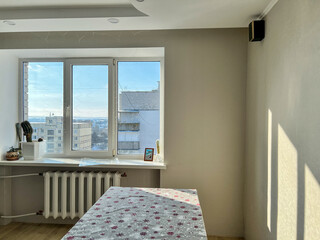 Morning sunlight streaming through apartment window onto wall